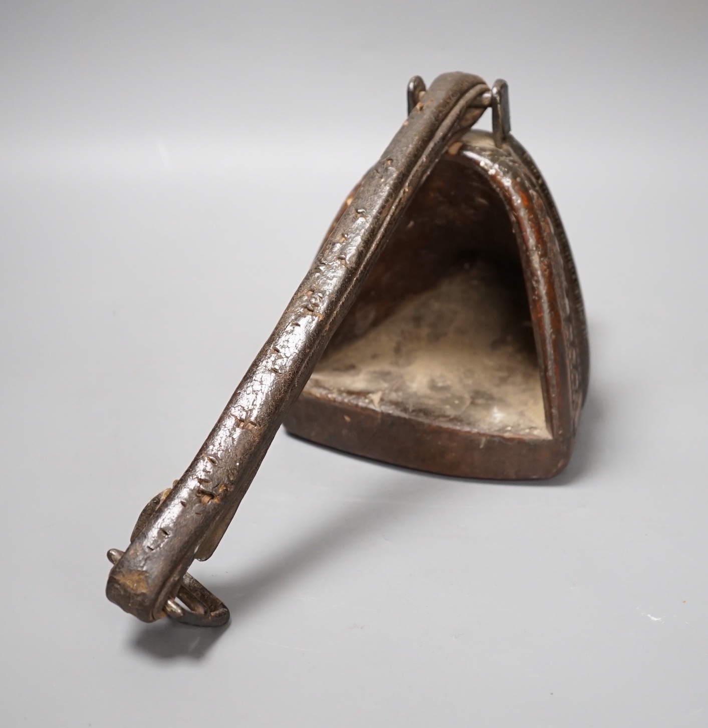 A 19th century Mongolian carved wood and bronze stirrup shoe